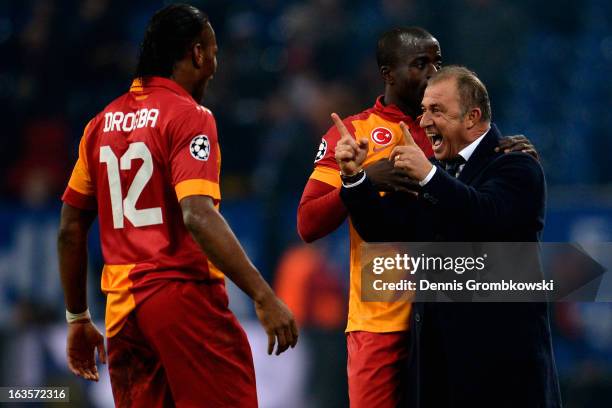 Head coach Fatih Terim of Galatasaray celebrates with Didier Drogba and Dany Nounkeu during the UEFA Champions League round of 16 second leg match...