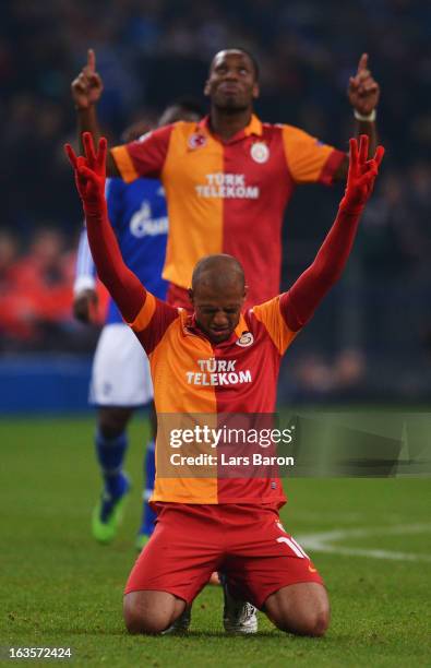 Felipe Melo of Galatasaray celebrates next to Didier Drogba after the UEFA Champions League round of 16 second leg match between FC Schalke 04 and...