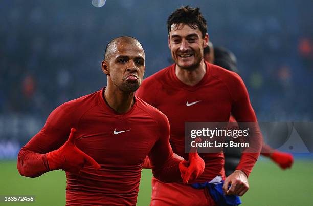 Felipe Melo of Galatasaray celebrates next to Albert Riera after the UEFA Champions League round of 16 second leg match between FC Schalke 04 and...