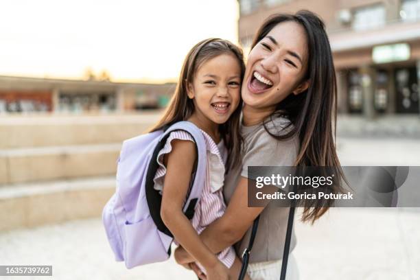 girl and mother having fun on the way to school - back to school stock pictures, royalty-free photos & images
