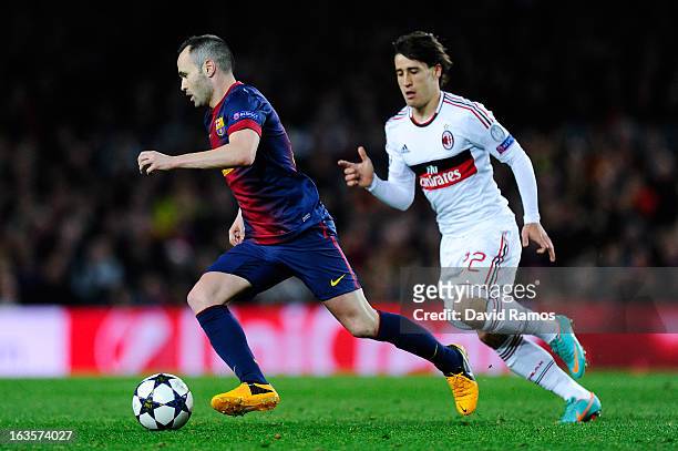 Andres Iniesta of FC Barcelona duels for the ball with Bojan Krkic of AC Milan during the UEFA Champions League round of 16 second leg match between...