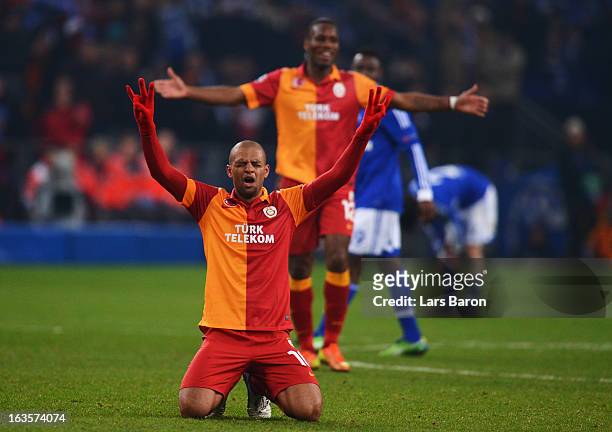 Felipe Melo of Galatasaray celebrates next to Didier Drogba after the UEFA Champions League round of 16 second leg match between FC Schalke 04 and...