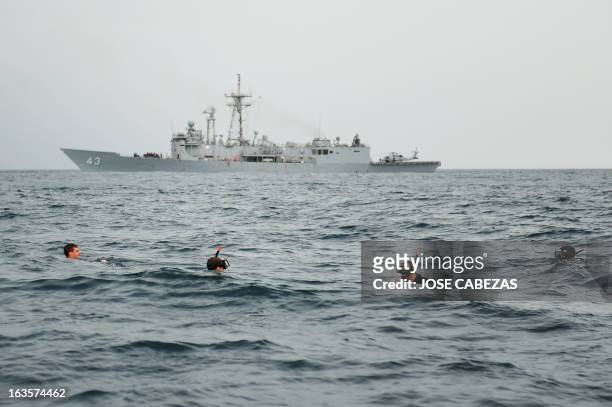 Navy swimmers participate in an exercise with the USS Thach on March 1 while patrolling in international waters in the Pacific Ocean off the coasts...