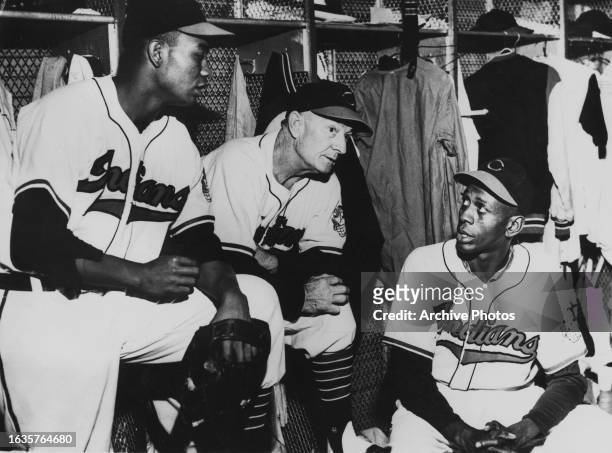 Larry Doby Centerfielder and Pinch Hitter, Bill McKechnie Coach and Satchel Paige , Right Handed Pitcher for the Cleveland Indians in the locker room...