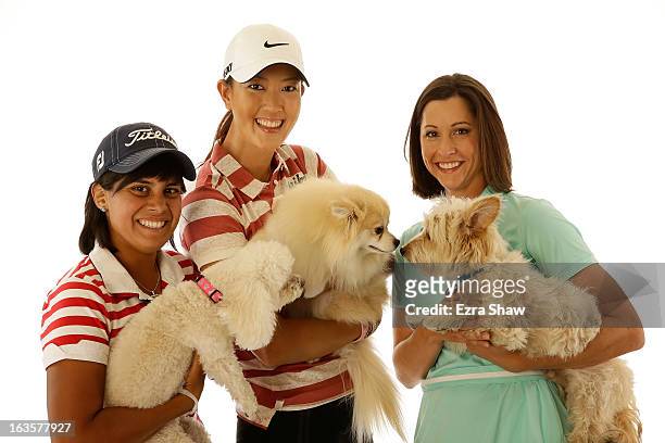 Players Julieta Granada of Paraguay, Michelle Wie, and Paige MacKenzie pose for a portrait with their dogs Bimba, Lola Taco Wie, and Charlie,...