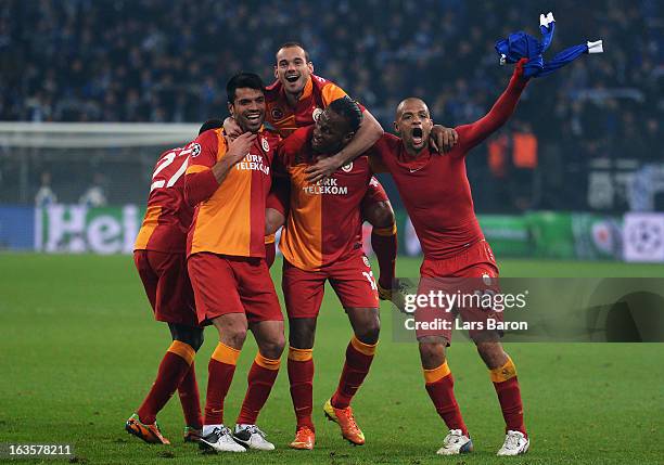 Wesley Sneijder and Didier Drogba of Galatasaray celebrate with team mates Goekhan Zan and Felipe Melo after winning the UEFA Champions League round...