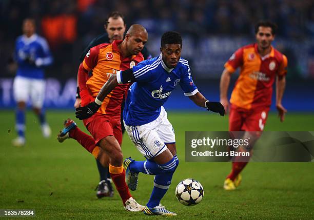 Felipe Melo of Galatasaray challenges Michel Bastos of Schalke the UEFA Champions League round of 16 second leg match between FC Schalke 04 and...