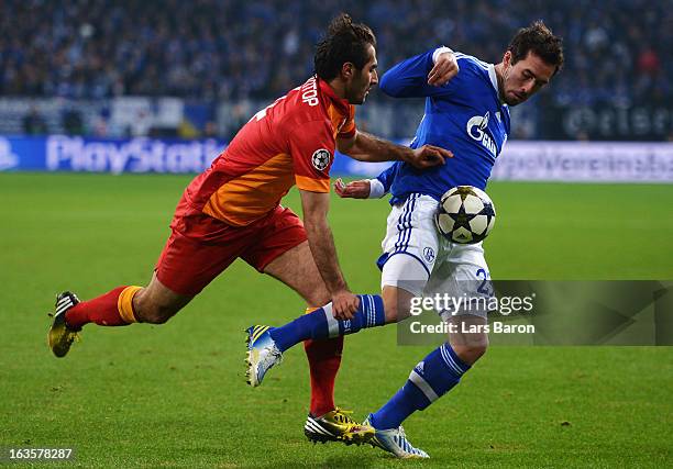 Hamit Altintop of Galatasaray challenges Christian Fuchs of Schalke during the UEFA Champions League round of 16 second leg match between FC Schalke...