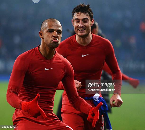 Felipe Melo of Galatasaray celebrates next to Albert Riera after the UEFA Champions League round of 16 second leg match between FC Schalke 04 and...