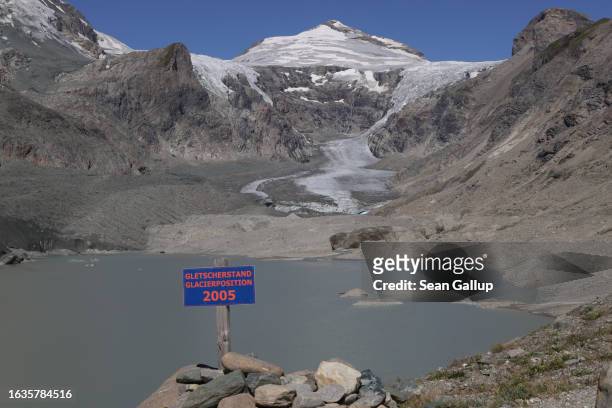 Sign marks the position where the Pasterze, Austria's biggest glacier, stood, both in length and height, in 2005, as the glacier face today lies...