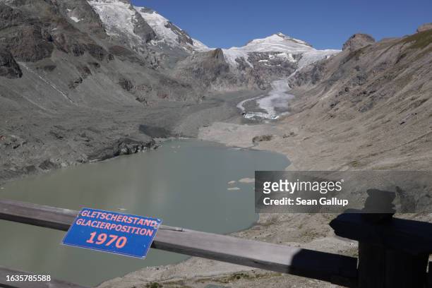 Sign marks the position where the Pasterze, Austria's biggest glacier, stood, both in length and height, in 1970, as the glacier face today lies...