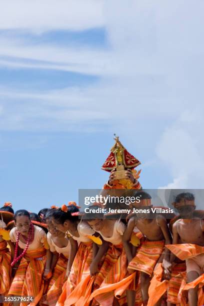 Performers from a local school carry the image of the Sto. Niño, the child Jesus, during the dance competition of the Pintados-Kasadyaan Festival in...