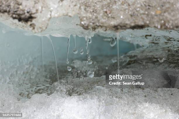 Water trickles from the face of the melting Pasterze, Austria's biggest glacier, on August 21, 2023 near Heiligenblut, Austria. Higher than average...