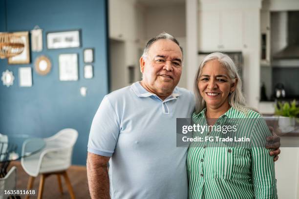 portrait of senior couple at home - real couple stock pictures, royalty-free photos & images