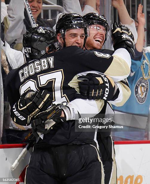 Brandon Sutter of the Pittsburgh Penguins celebrates his game-winning goal with Sidney Crosby and James Neal during the third period against the...