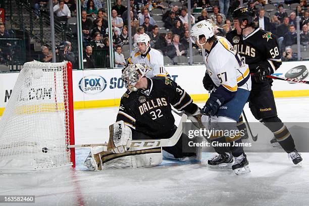 Gabriel Bourque and David Legwand of the Nashville Predators get a puck in the net past Kari Lehtonen and Jordie Benn of the Dallas Stars at the...