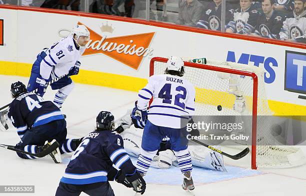 Phil Kessel and Tyler Bozak of the Toronto Maple Leafs watch as the puck goes in behind goaltender Ondrej Pavelec of the Winnipeg Jets for Kessel's...