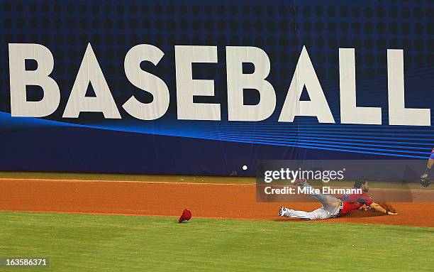 Angel Pagan of Puerto Rico misses a fly ball with the bases loaded during a World Baseball Classic second round game against the United States at...