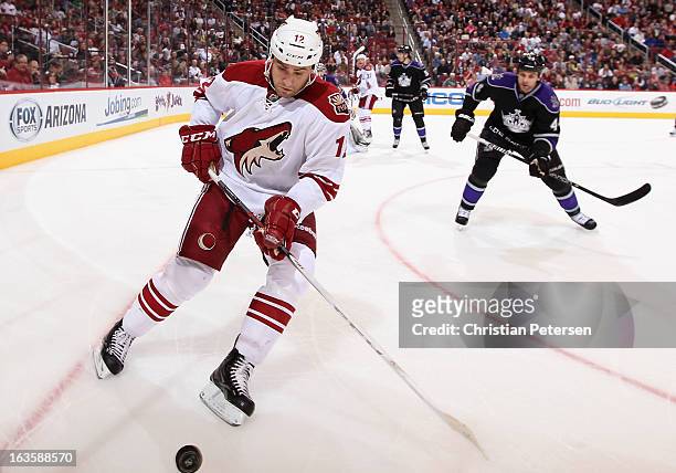 Paul Bissonnette of the Phoenix Coyotes plays the puck as Davis Drewiske of the Los Angeles Kings skates in during the third period of the NHL game...