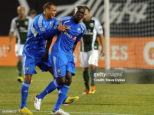 Hassoun Camara of Montreal Impact celebrates with Matteo Ferrari of Montreal Impact after Cmara scored a goal during the first half of the game...