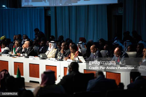 Delegates look on as Vladimir Putin, president of Russia delivers a speech at a meeting during the 2023 BRICS Summit at the Sandton Convention Centre...
