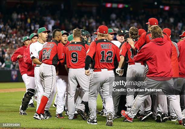 Tyson Gillies, Rene Tosoni, manager Ernie Whitt and teammates come together in an on field altercation with players from Mexico during the World...