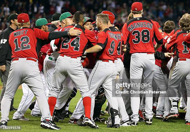 Manager Ernie Whitt, Tyson Gillies, Rene Tosoni, Trystan Magnuson and teammates come together in an on field altercation with players from Mexico...