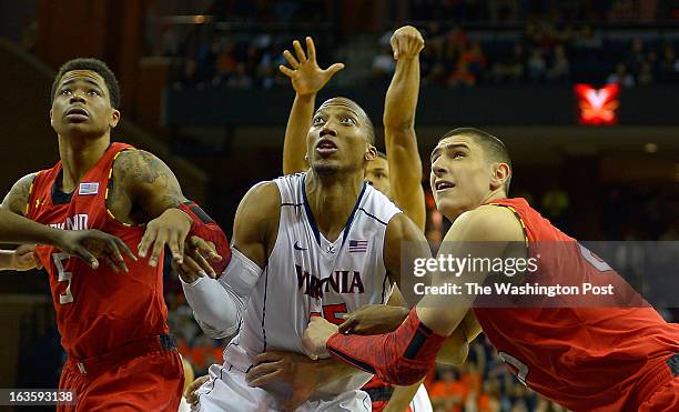 Maryland guard Nick Faust , left, Virginia forward Akil Mitchell , center,and Maryland center Alex Len position themselves for a rebound as the...