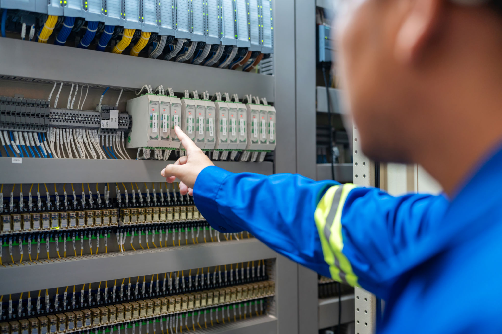 Close up hand of Electrical engineer inspecting a circuit breaker at the switchgear room in a factory to maintain power supply and preventing disruptions. Ensures the continued smooth operation of Industrial Equipment. Amidst the controlled environment. Close up hand of Electrical engineer inspecting a circuit breaker at the switchgear room in a factory to maintain power supply and preventing disruptions. Ensures the continued smooth operation of Industrial Equipment. Amidst the controlled environment.