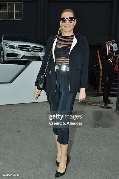 Fashion week guest wearing Sandro coat, Cos top, Cazabat shoes, Chanel bag and Zara glasses is seen during Mercedes-Benz Fashion Week Istanbul...