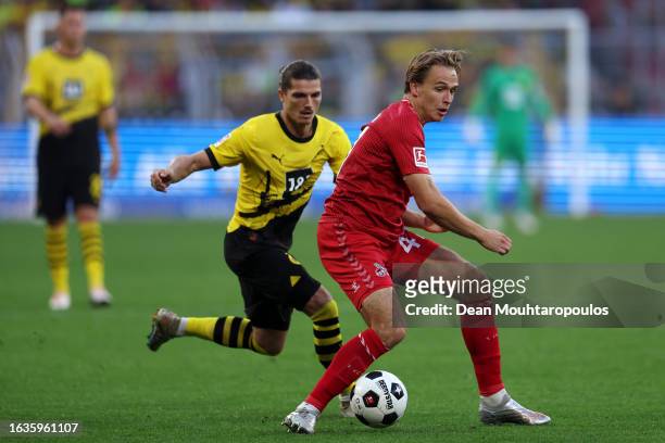 Mathias Olesen of 1.FC Köln battles for possession with Marcel Sabitzer of Borussia Dortmund during the Bundesliga match between Borussia Dortmund...
