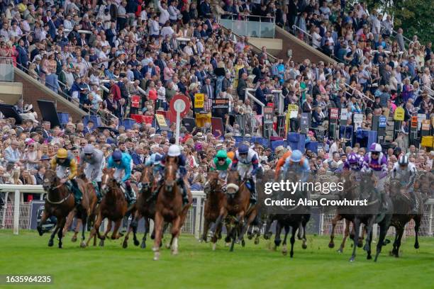 Racegoers look on as runners ease down after finishing The Goffs UK Harry Beeby Premier Yearling Stakes at York Racecourse on August 24, 2023 in...