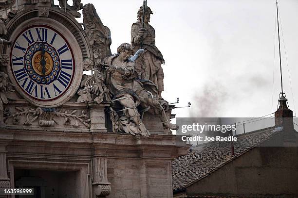 Smoke is seen coming from the chimney on the roof of the Sistine Chapel as Cardinals enter their 2nd day of the conclave on March 13, 2013 in Vatican...