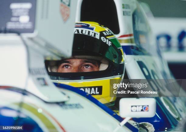 Ayrton Senna from Brazil checks the lap times on the monitor from the cockpit of the Rothmans Williams Renault Williams FW16 Renault V10 inside the...