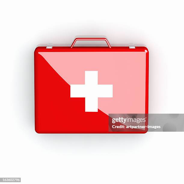 red first aid case with white cross on white - trousse de secours photos et images de collection