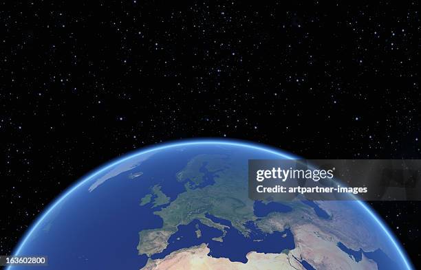 blue globe with europe against a black nightsky - wereldbol europa stockfoto's en -beelden
