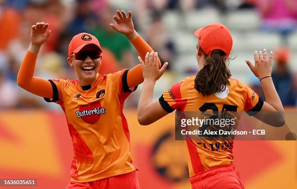 Issy Wong of Birmingham Phoenix celebrates with teammate Tess Flintoff after catching out Sophie Luff of London Spirit during The Hundred match...
