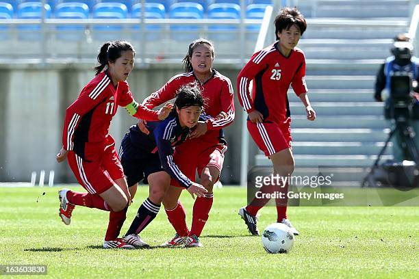 Mari Kawamura of Japan challenges Pu Wei and Wang Lisi of China during the Algarve Cup 2013 fifth place match at the Estadio Algarve on March 13,...