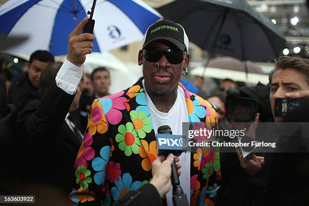 Basketball star Dennis Rodman walks near to the Vatican as he shows support for a black papal candidate on March 13, 2013 in Vatican City, Vatican....