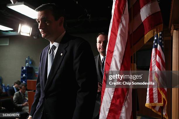 Sen. Ted Cruz and Sen. Mike Lee leave after holding a news conference to announce their plan to defund the Patient Protection and Affordable Care...