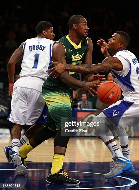 Toarlyn Fitzpatrick of the South Florida Bulls passes the ball as Fuquan Edwin of the Seton Hall Pirates defends at Madison Square Garden on March...