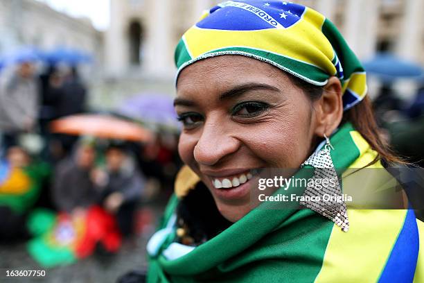 Supporter of the Brazilian Cardinal Odilo Pedro Scherer smiles as she waits in St Peter's Square for news on the election of a new Pope on March 13,...