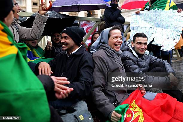 Supporters of the Brazilian Cardinal Odilo Pedro Scherer gather in St Peter's Square as they wait for news on the election of a new Pope on March 13,...
