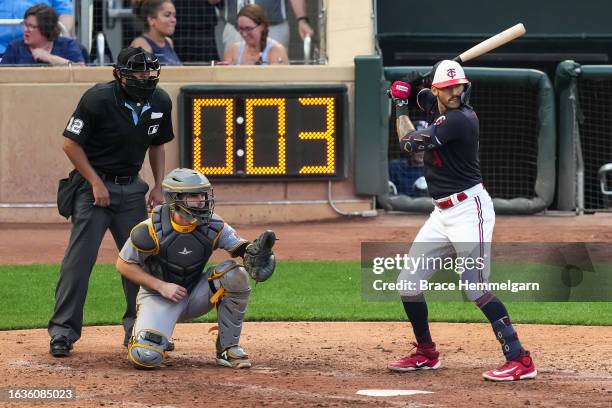 Carlos Correa of the Minnesota Twins bats in front of the pitch clock against the Pittsburgh Pirates on August 19, 2023 at Target Field in...