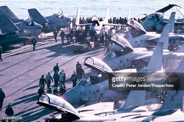 Grumman A-6 intruder attack aircraft, on left, and Grumman F-14 Tomcat fighter aircraft from the Carrier air wing on the flight deck of the United...