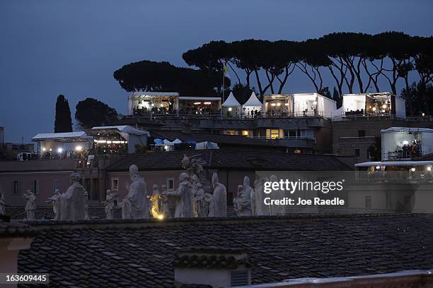 Members of the media work in temporary television studios across from St Peter's Square as they report on the conclave to elect a new Pope on March...