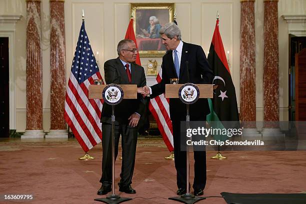 Secretary of State John Kerry and Libyan Prime Minister Ali Zeidan shake hands during a news conference in between bilateral meetings in the Ben...