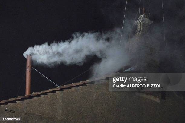 White smoke rises from the chimney on the roof of the Sistine Chapel meaning that cardinals elected a new pope on the second day of their secret...