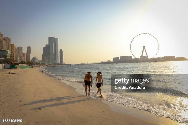 People spend time at JBR Beach on the coast of the Persian Gulf in Dubai, United Arab Emirates on August 30, 2023.