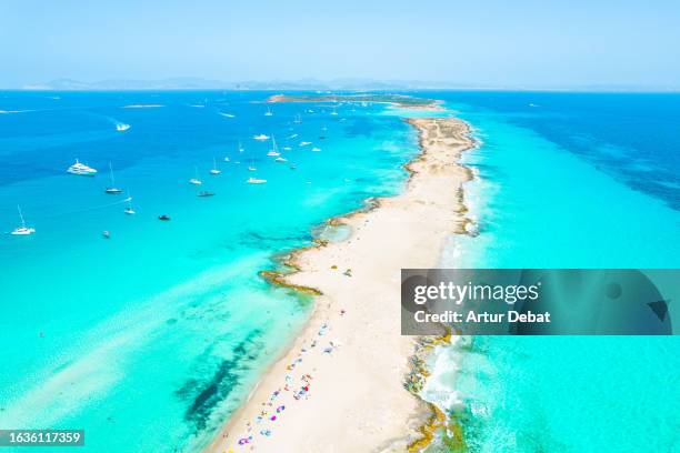 aerial view by drone flying above the paradise island of formentera in spain with the ibiza island in the background. - formentera foto e immagini stock